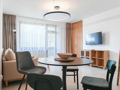 a living room with a table and chairs at Guest House 7 in Bansko