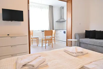 a bedroom with a bed and a living room at Guest House 7 in Bansko