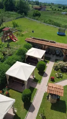 an aerial view of a park with picnic tables and a playground at Sharkov Family Hotel in Ognyanovo