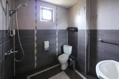 a bathroom with a toilet and a sink and a shower at Sharkov Family Hotel in Ognyanovo