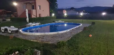 a swimming pool in the yard of a house at Къщи за гости Ореха in Samokov
