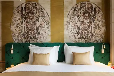 a bed with a green headboard and two mirrors at Gallery 37 Powered by ASTON in Plovdiv