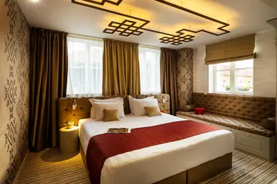 a hotel room with a large bed and windows at Gallery 37 Powered by ASTON in Plovdiv