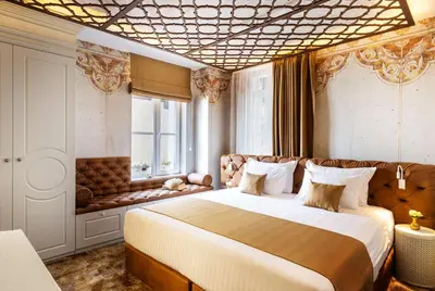 a bedroom with a large bed and a window at Gallery 37 Powered by ASTON in Plovdiv