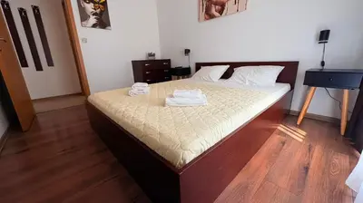 a bedroom with a bed with two towels on it at ASPEN GOLF RESORT Ski & Spa RELAX APARTMENT in Bansko
