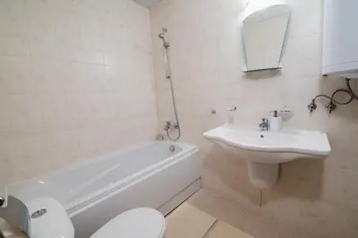 a bathroom with a sink and a tub and a toilet at ASPEN GOLF RESORT Ski & Spa RELAX APARTMENT in Bansko