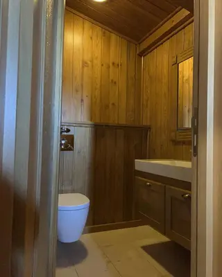 a bathroom with a toilet and a sink at House in Pirin Golf Bansko in Razlog