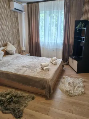 a bedroom with a bed with two towels on it at Iskra Apartment in Sofia