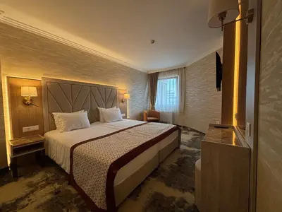 a hotel room with a bed and a television at Hissar Spa Hotel in Hisarya