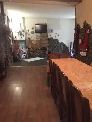 a dining room with a table and chairs in a room at Къща за гости Спасителна in Brezhani