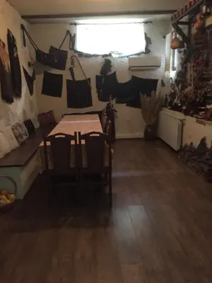 a room with a table and chairs and a window at Къща за гости Спасителна in Brezhani
