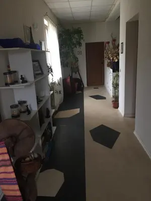 a hallway with black and white floors and a room at Къща за гости Спасителна in Brezhani