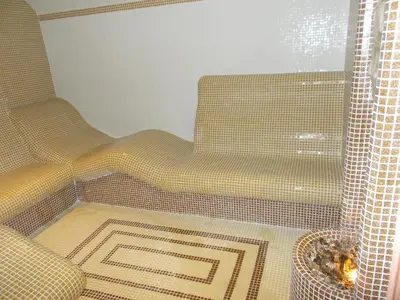 a living room with a couch and a window at Panorama Family Hotel in Zlatograd