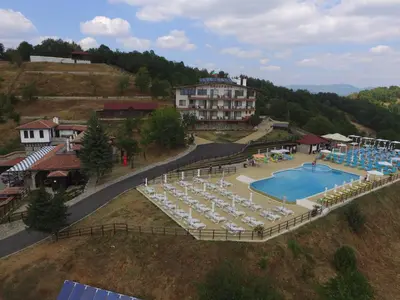 an aerial view of a resort with a pool and chairs at Panorama Family Hotel in Zlatograd