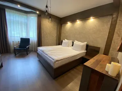 a bedroom with a bed and a chair in it at Deluxe 206 in Borovets