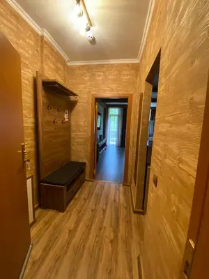 a hallway with wooden walls and a bench in a room at Deluxe 206 in Borovets