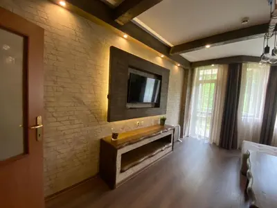 a living room with a tv on a brick wall at Deluxe 206 in Borovets