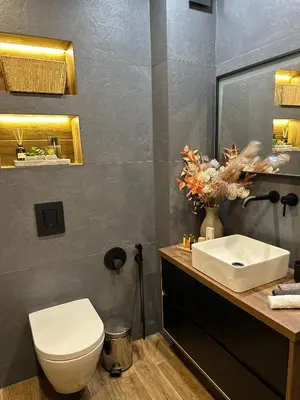 a bathroom with a white toilet and a sink at Deluxe 206 in Borovets