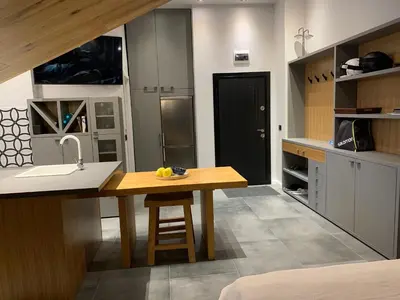 a kitchen with a wooden table and a sink at Silver Box Pamporovo in Pamporovo