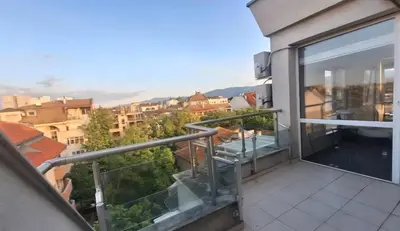 a balcony with a view of a city at AHINORA in Plovdiv