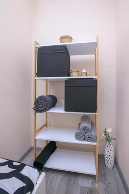 a book shelf with towels on it in a room at Babylon Park Apartment in Sandanski