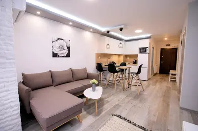a living room with a couch and a table at Babylon Park Apartment in Sandanski