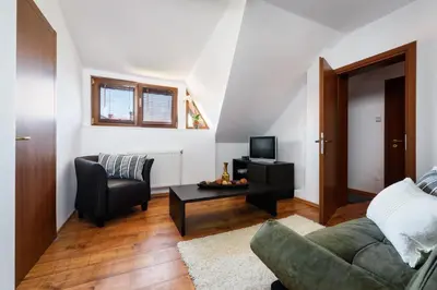 a living room with a couch and a table at TWO BEDROOM Apartment in Bansko