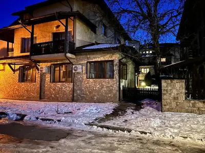 a house in the snow at night at Top Lodge twobedroom apartment in Bansko