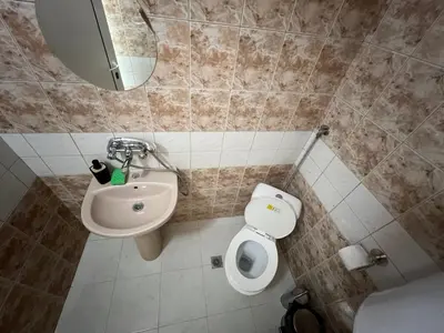 a bathroom with a toilet and a sink at Студио Рози апартамент in Sandanski