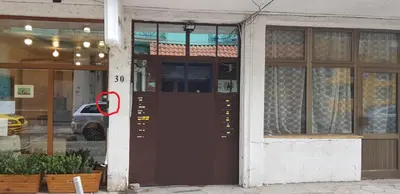 a red circle on the door of a building at Ancient Serdica 2BDR Family Friendly City Retreat in Sofia