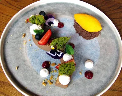 a plate of food with vegetables and fruit on it at Ancient Serdica 2BDR Family Friendly City Retreat in Sofia
