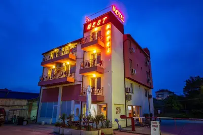 a hotel with a neon sign on the side of it at Hotel West in Blagoevgrad