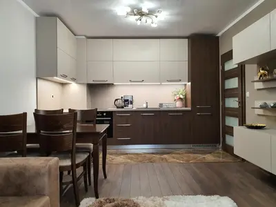 a kitchen and dining room with a table and chairs at VIP apartment & parking in Sofia