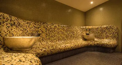 a bathroom with a sink on a tiled wall at Lake View Apartment in Pamporovo