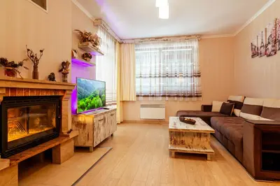a living room with a couch and a fireplace at Lake View Apartment in Pamporovo