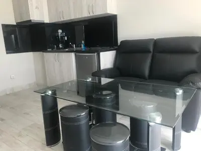 a living room with a glass table and a couch at NORTH PARK SUITE in Sofia