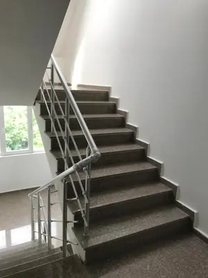 a staircase with a metal railing in a building at NORTH PARK SUITE in Sofia