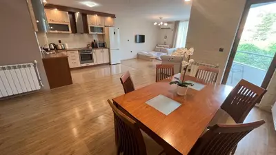 a dining room and kitchen with a table and chairs at Apartment City Park Sandanski in Sandanski