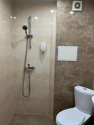 a bathroom with a shower stall with a toilet at Apartment City Park Sandanski in Sandanski