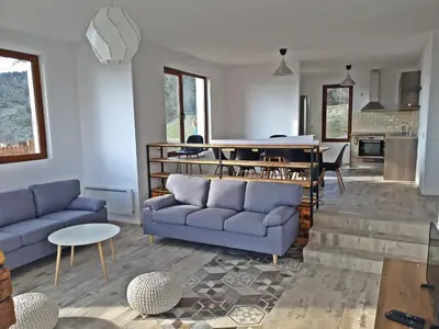 a living room with two blue couches and a table at Farmhopping Village in Dobărsko