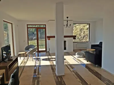 a living room with a couch and a table at Farmhopping Village in Dobărsko