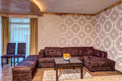 a living room with a couch and a table at Вили Forest Nook in Pamporovo