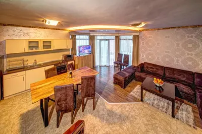 a living room with a couch and a table at Вили Forest Nook in Pamporovo