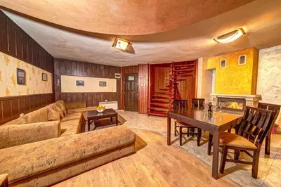a living room with a couch and a table at Вили Forest Nook in Pamporovo
