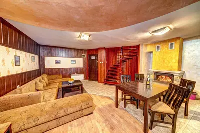 a living room with a couch and a table at Вили Forest Nook in Pamporovo