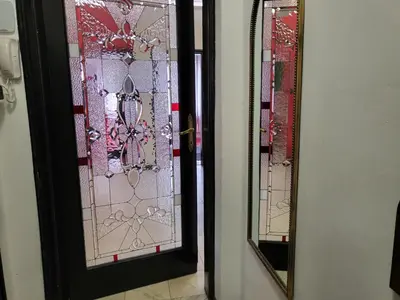 two stained glass mirrors on a bathroom door at TOP CENTER spacious apartment with free parking in Sofia