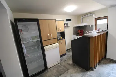 a kitchen with a black and white refrigerator at Къща за гости Перуника in Sapareva Banya