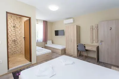 a hotel room with a bed and a mirror at Къща за гости Перуника in Sapareva Banya