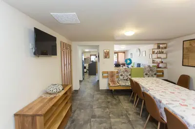 a room with a table and chairs and a dining room at Къща за гости Перуника in Sapareva Banya
