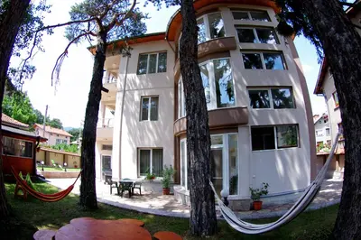 a building with a hammock in front of it at Приятелската къща in Velingrad